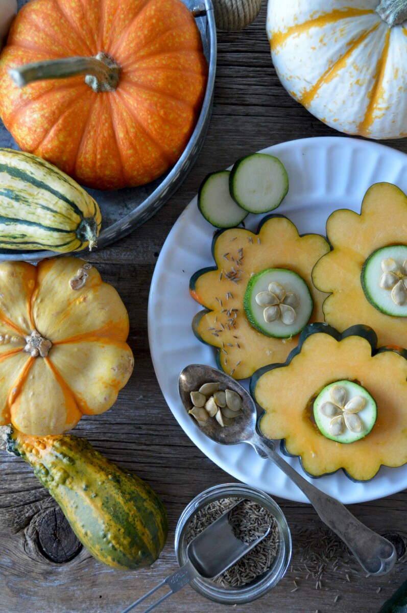 whole and sliced pumpkins with pumpkin seeds.