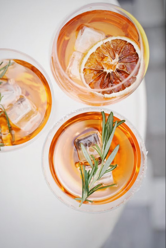 glasses of orange rosemary sparkler mocktail